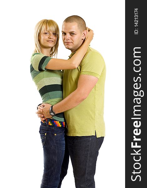 Happy young embracing couple standing  over white background