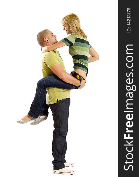 Young man holding his girlfriend in the air over white. Young man holding his girlfriend in the air over white