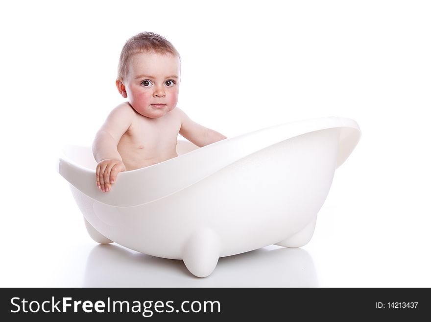 Boy in white bath tub on white background