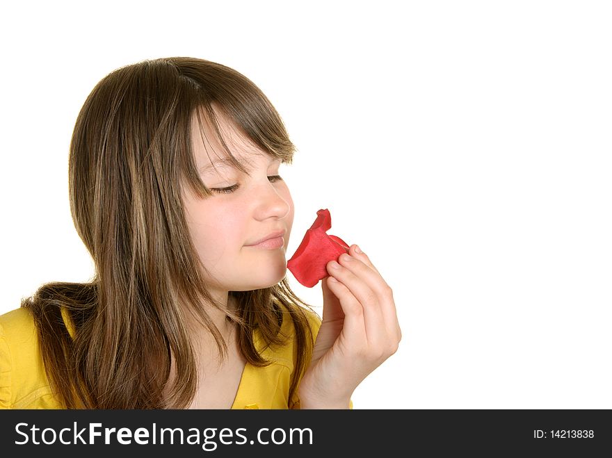 Girl holds petal of flower and smells isolated in white