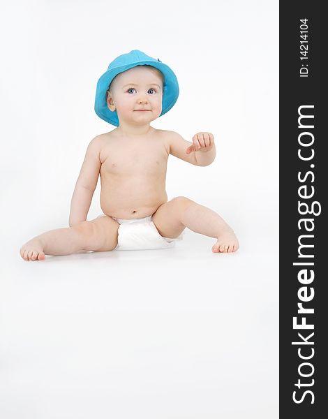 Lovely infant in blue hat on white background. Lovely infant in blue hat on white background.