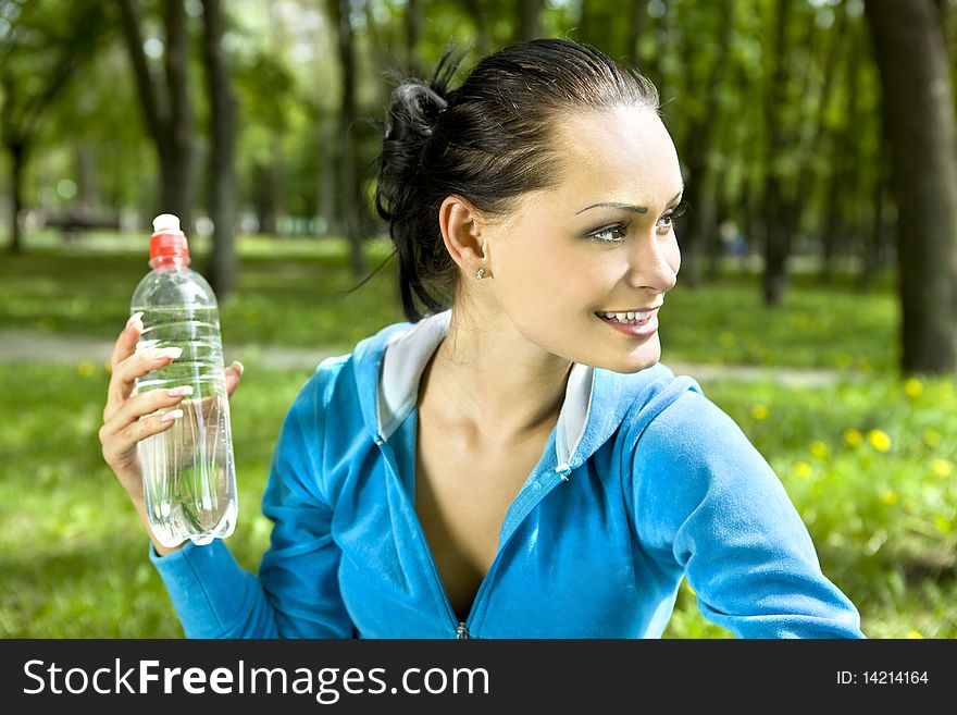 Pretty young girl runner in the forest with bottle of water. Pretty young girl runner in the forest with bottle of water