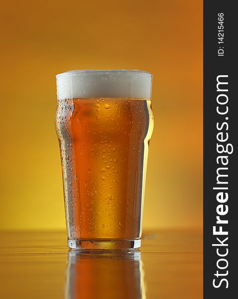 Fresh Refreshing Beer On A Golden Background