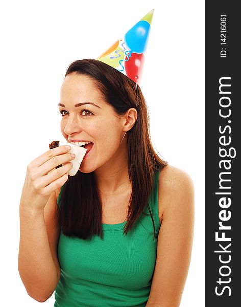 Woman biting on piece of cake wearing party hat. Woman biting on piece of cake wearing party hat
