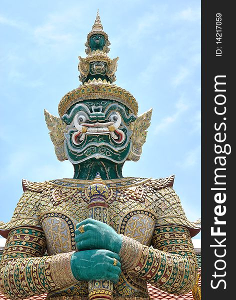 Thai giant statue stand in front of temple at emerald buddha temple. onece of historical statue in thailand.