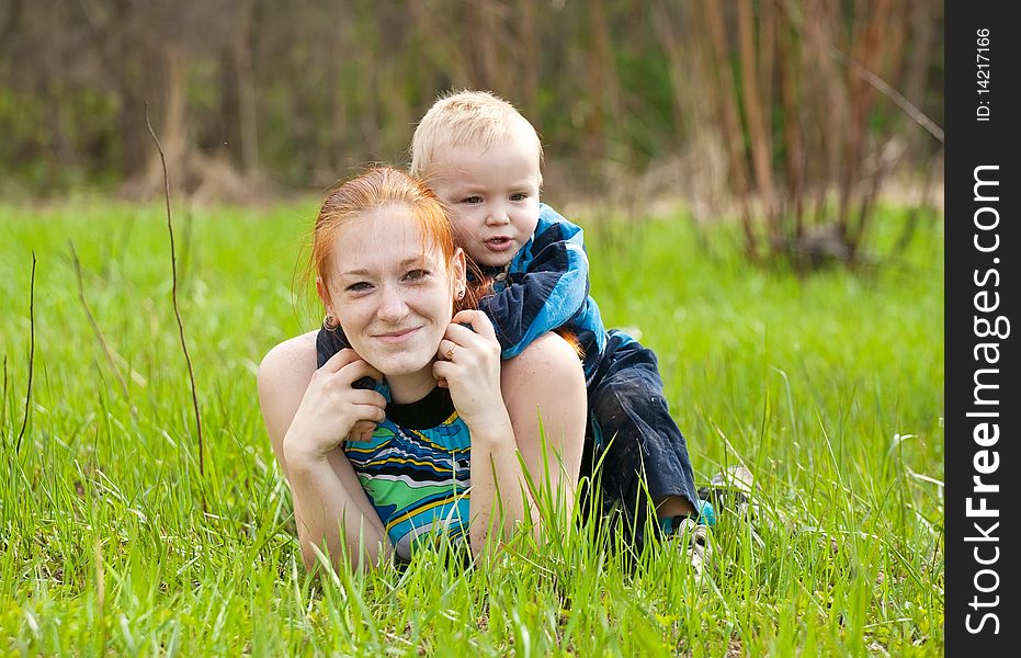 Happy mother with her son on meadow