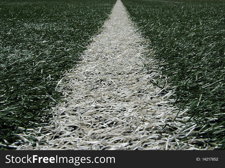 Closeup of white line on turf in sports stadium. Closeup of white line on turf in sports stadium