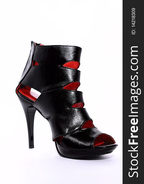 Black female boot with a red lining on a white background
