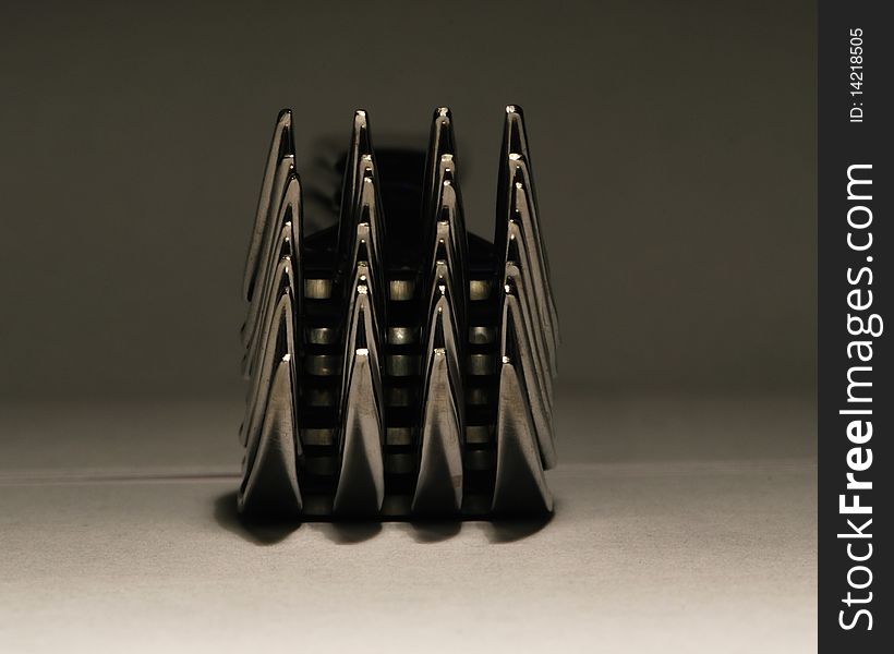 A stack of dinner forks viewed from the pointed ends. A stack of dinner forks viewed from the pointed ends