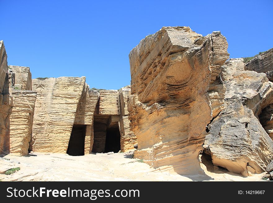 The tuff quarry with its unique stone contrasts with the blue sky