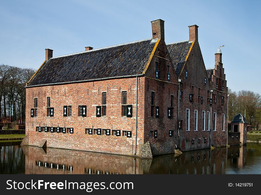 Old medieval mansion with water defence around