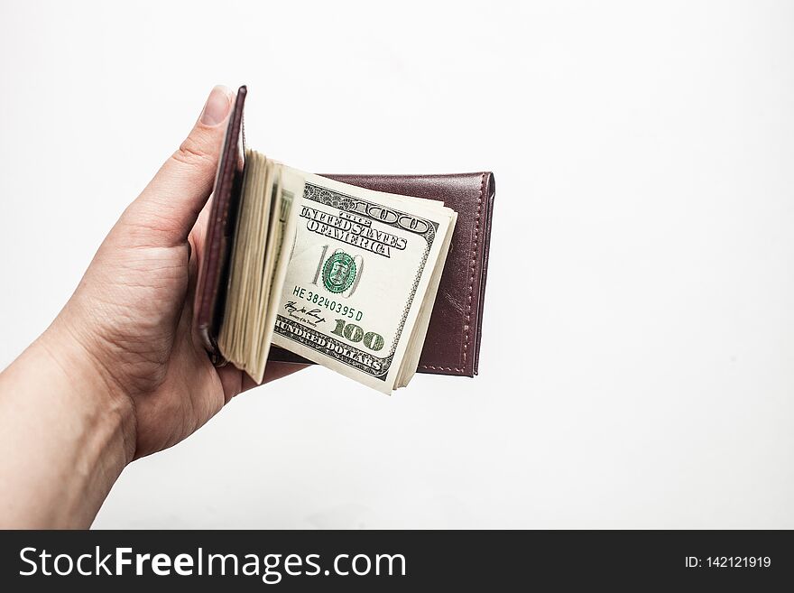 Women Hand Holding A Wallet Full Of One Hundred Dollar Bills Isolated Over A White Background