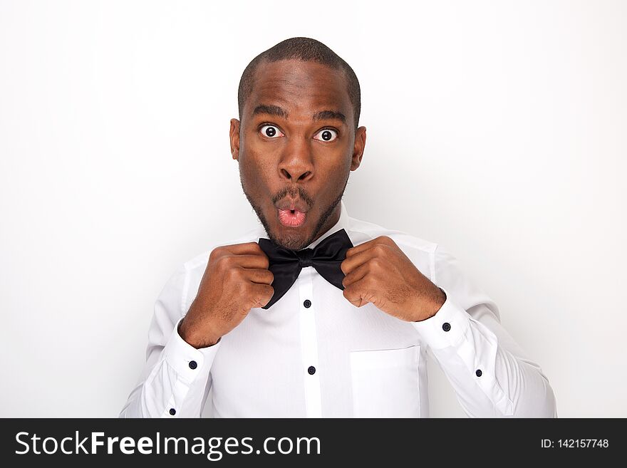 Close up portrait of african american man making a face white adjusting bowtie