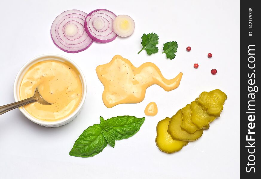 Sauce for hamburgers Basil leaves and parsley and pepper sliced onion and pickled cucumber white background