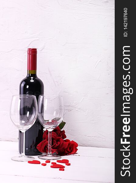 Happy Valentine`s Day with red wine, red roses, wine glasses and hearts in love