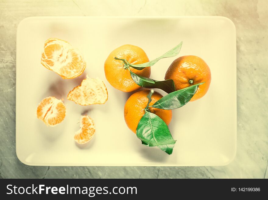 Ripe juicy mandarines in vintage style - retro still life and healthy nutrition concept. Tangerine delight