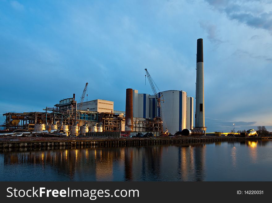 Demolition of an industrial factory at sunset