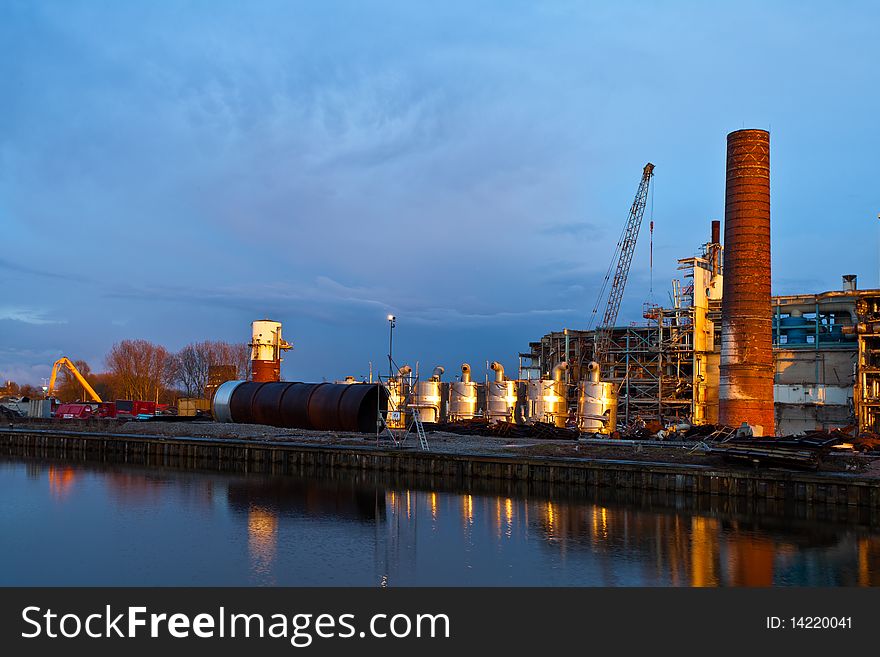 Demolition of an industrial factory at sunset