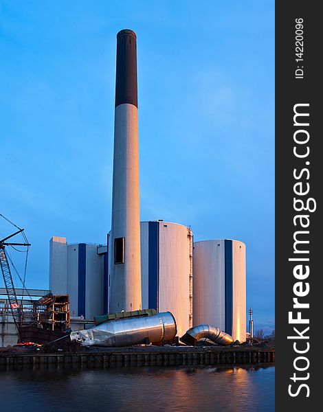 Demolition of an industrial factory at sunset