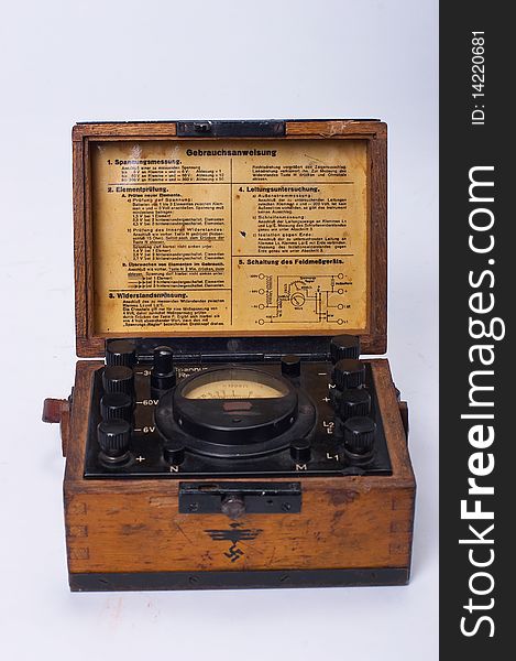 The ancient brown voltmeter in a wooden case