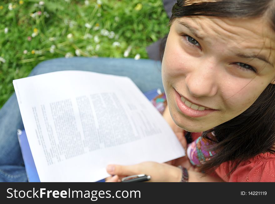 Young student learns in the park