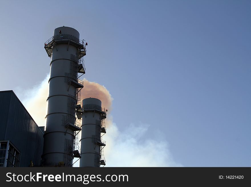 Pollution streams from Smokestack at power plant under construction. Pollution streams from Smokestack at power plant under construction