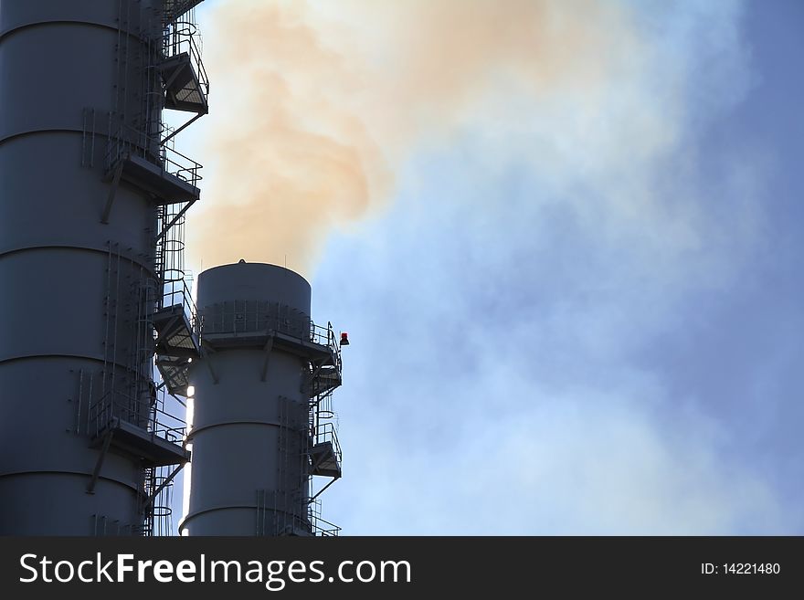 Pollution streams from Smokestack at power plant. Pollution streams from Smokestack at power plant