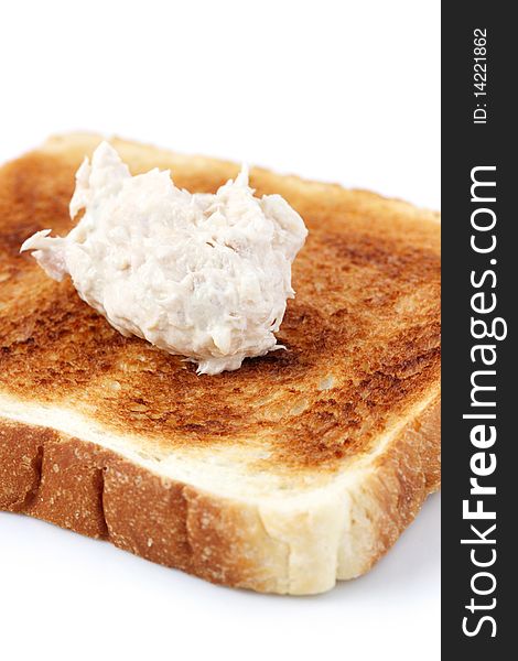 A piece of baked bread with mayonnaise tuna isolated on white background. A piece of baked bread with mayonnaise tuna isolated on white background.