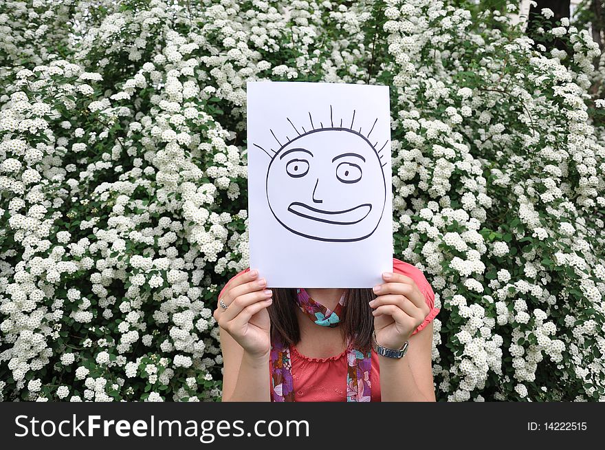 Beautiful young girl with a sheet of paper over the face. Beautiful young girl with a sheet of paper over the face