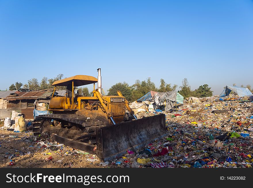 Bulldozer in the middle of garbage dump