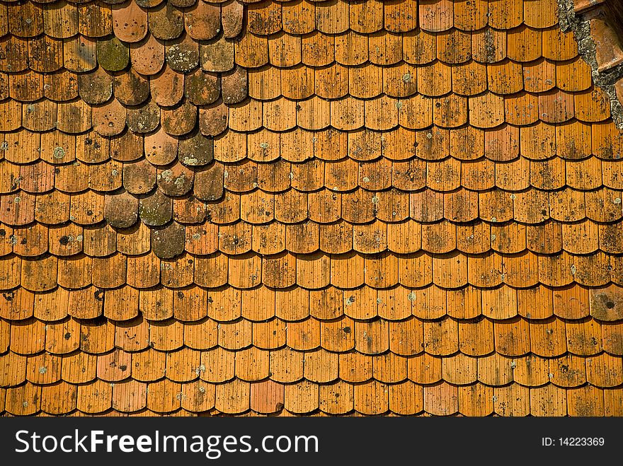 Uneven roof tiles marked by time. Uneven roof tiles marked by time