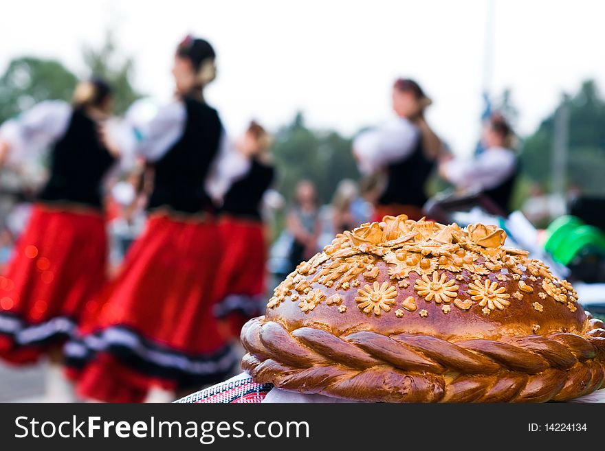 Festive loaf on a background of dancing people. Festive loaf on a background of dancing people