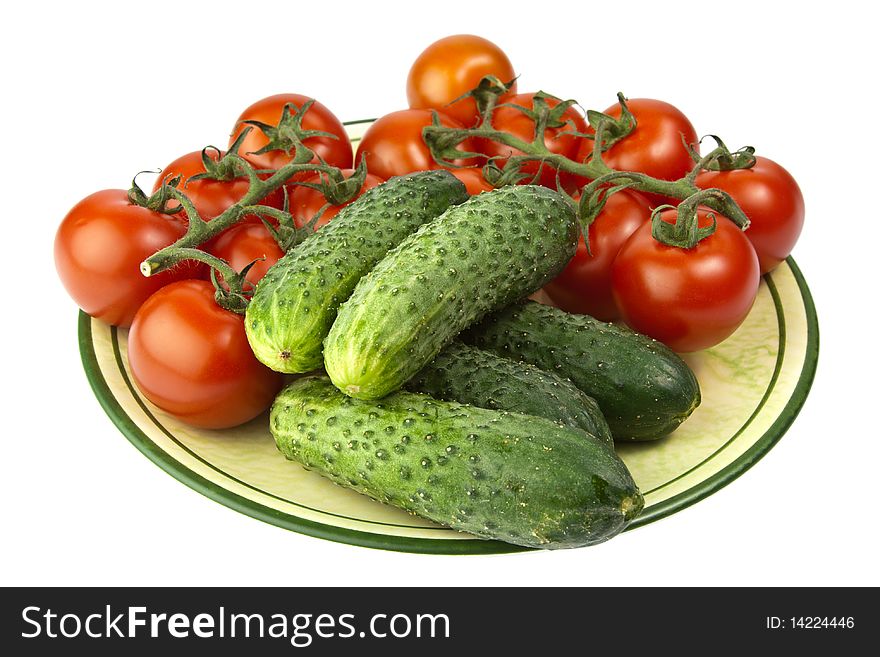 Fresh raw tomatoes and cucumbers on a plate. Fresh raw tomatoes and cucumbers on a plate