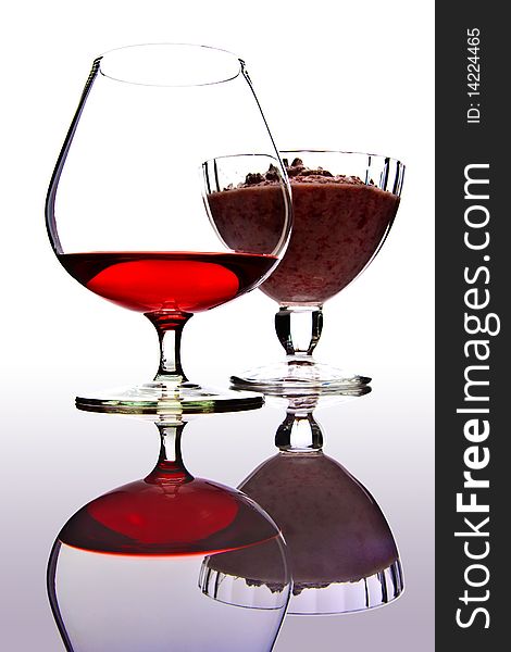 A wineglass and ice-cream bowl on the reflection surface. A wineglass and ice-cream bowl on the reflection surface