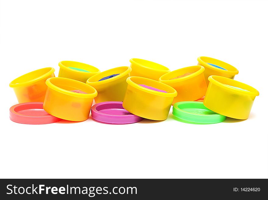 Rows of containers with colorful plasticine on a white background