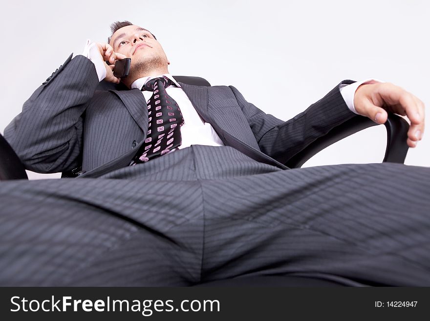 Relaxed businessman speaking on the telephone