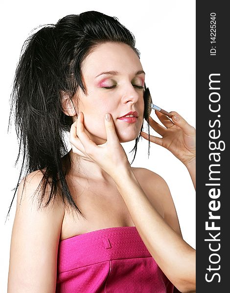 Portrait of attractive young woman applying blusher, clipping path