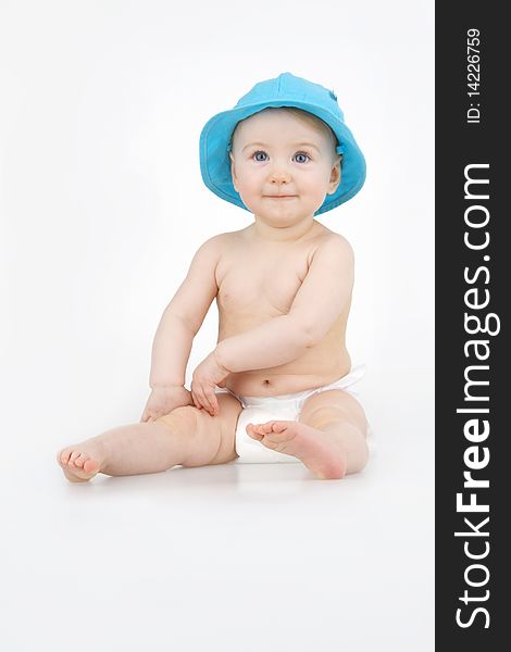 Merry child in blue hat on white background. Merry child in blue hat on white background.