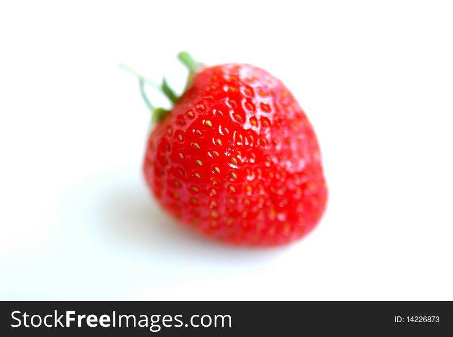 Closeup view of fresh red strawberry isolated and blurred on a white background. Closeup view of fresh red strawberry isolated and blurred on a white background