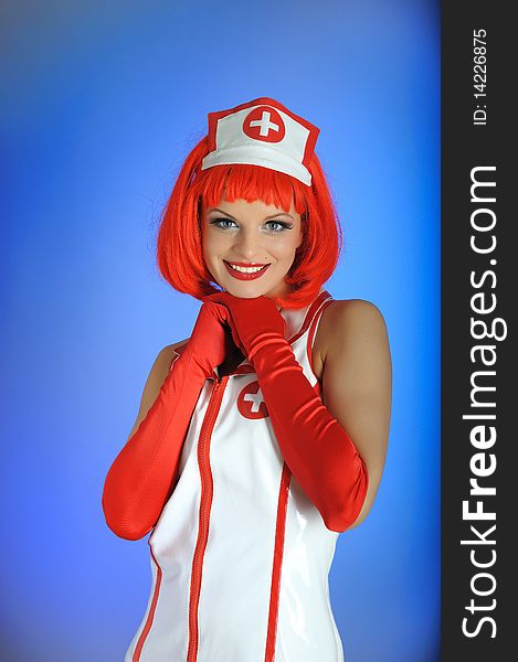 Young beautiful sexy doctor in uniform and red hair