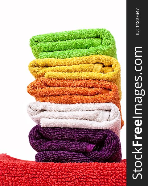 Stacked colorful towels isolated on a white background. Stacked colorful towels isolated on a white background.