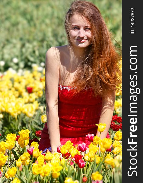 Young beautiful woman in yellow tulips