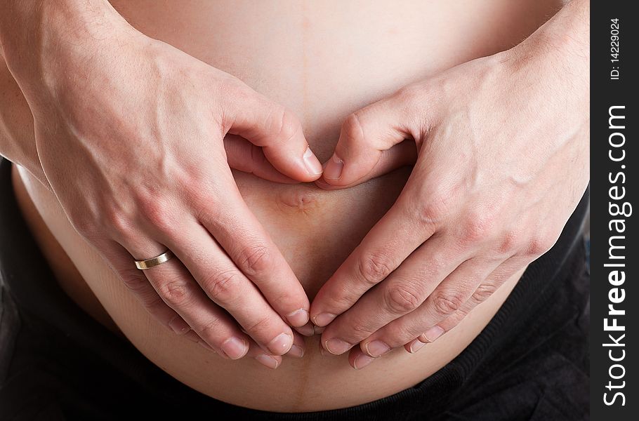 Advanced pregnant belly with hands