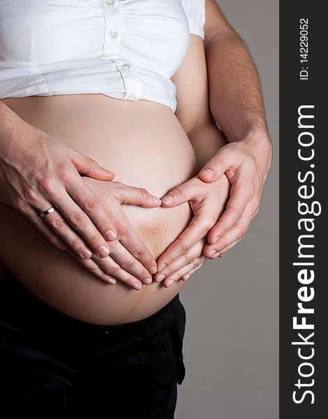 Advanced pregnant belly with hands