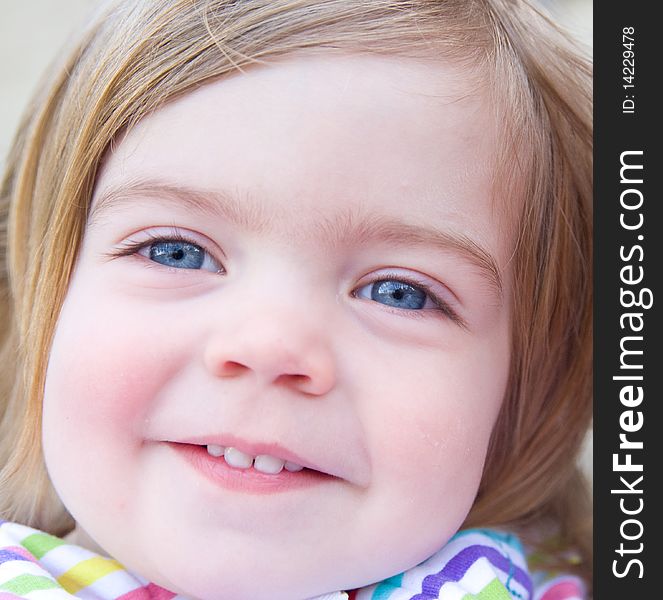 Portrait Of A Smiling Baby Girl.