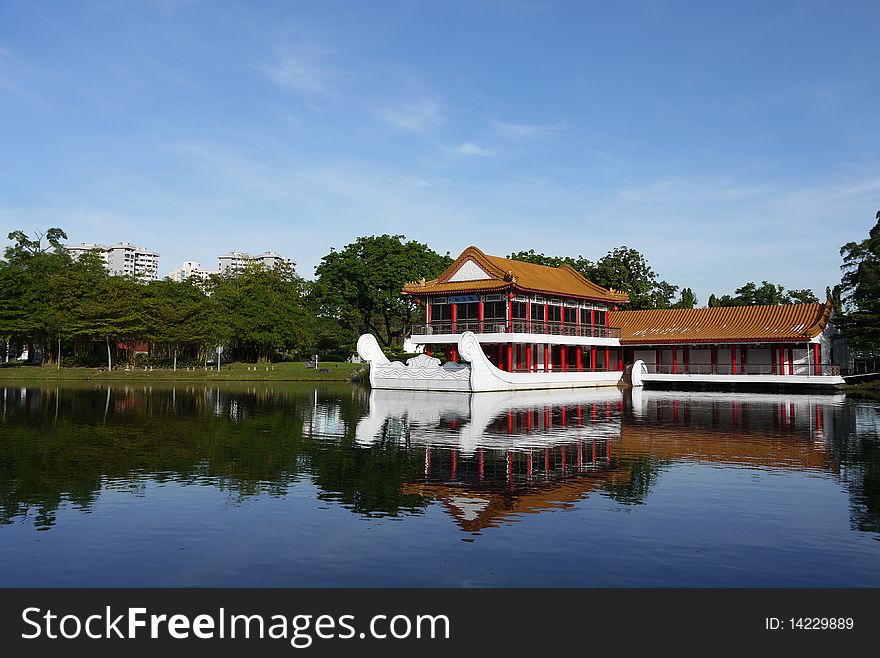 A beautiful stone boat with teahouse pavilion built above its deck sits on the lagoon at Chinese Garden