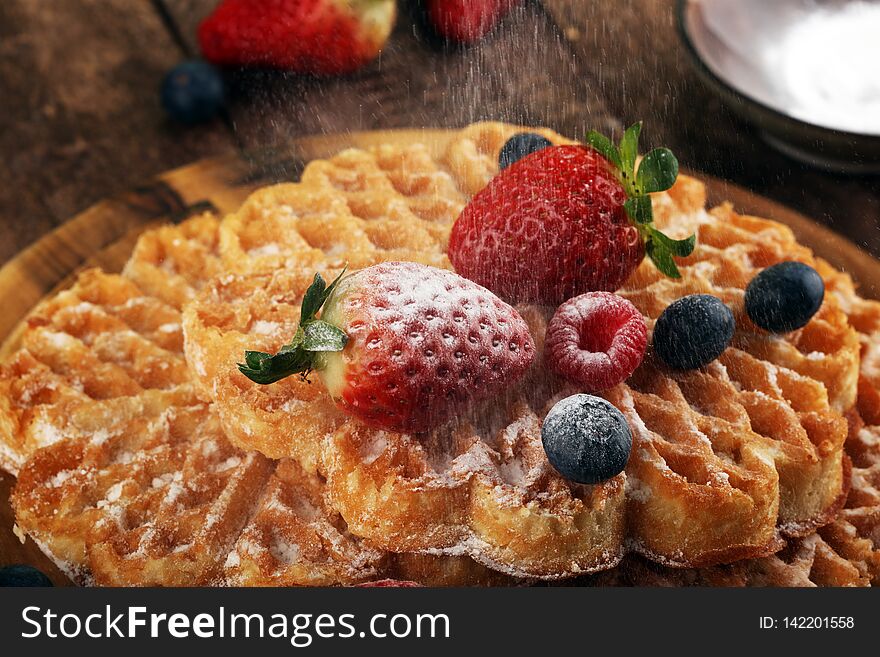 Waffle. Traditional belgian waffles with fresh fruit and powder sugar on wood