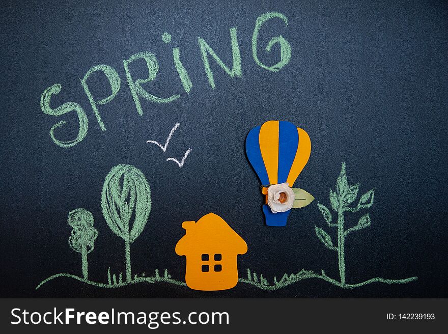 Funny composition on the theme of spring in a cartoon style, house, forest and a balloon