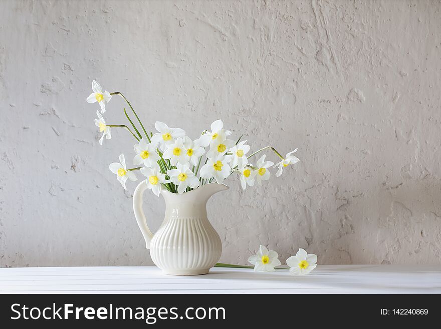 Daffodils In Jug On White Background