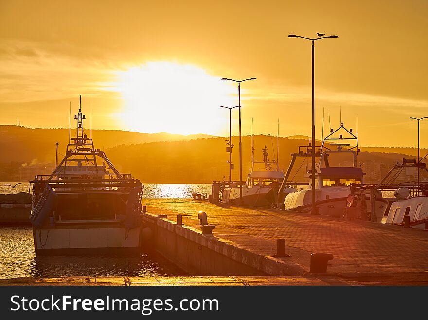 Sunset light in a harbor the Spanish town Palamos in Costa Brava.